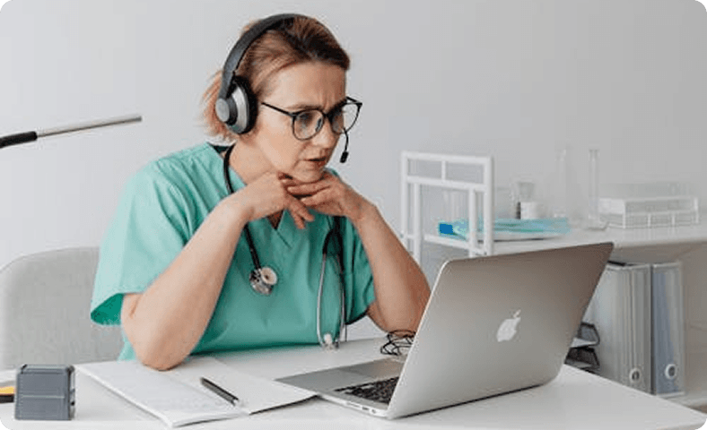 Doctor with headset working on laptop